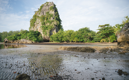 Wide angle rocky mountain and tide tropical beach sea at krabi thailand