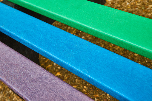 Image of Abstract pride LGBTQ bench with rainbow colors green and blue and purple on bench panels