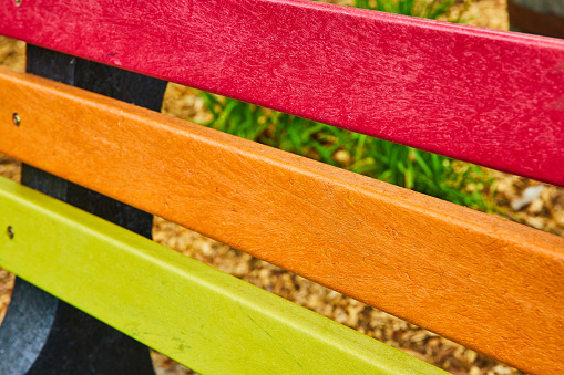 Image of Abstract pride LGBTQ bench with rainbow colors red and orange and yellow on bench panels