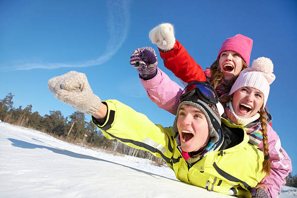 A family having fun outdoors in the wintertime stock photo