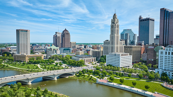 Image of Aerial Columbus Ohio with bright blue sky with clouds and bridge over Scioto river