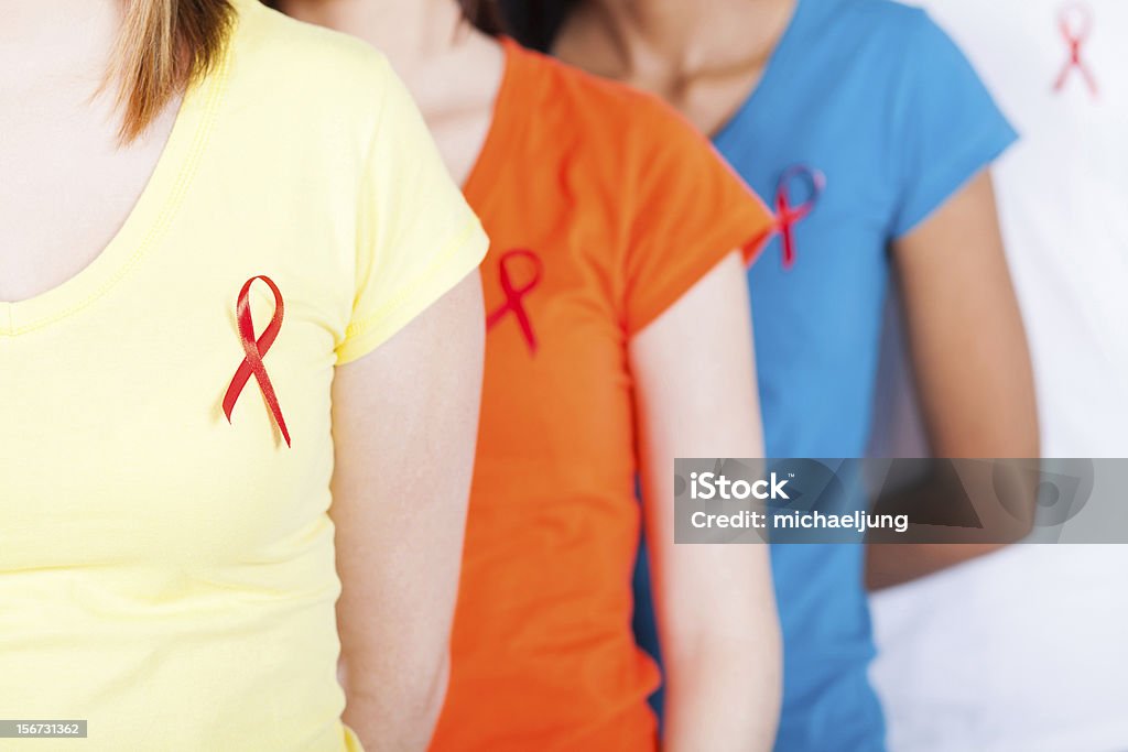 AIDS HIV awareness group of young people with red ribbon on their chest for AIDS HIV awareness AIDS Stock Photo