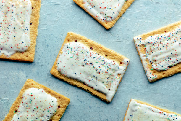 istock Pop tarts layout. Poptart toaster pastry with icing on a blue slate background 1567323567