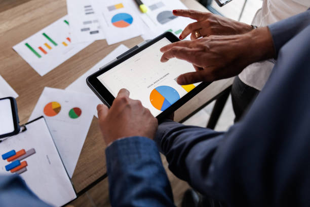 istock Businessman scrolling through various data on digital tablet during a meeting 1567327985