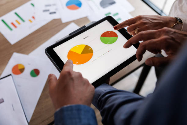 istock Businessman scrolling through various data on digital tablet during a meeting 1567328126