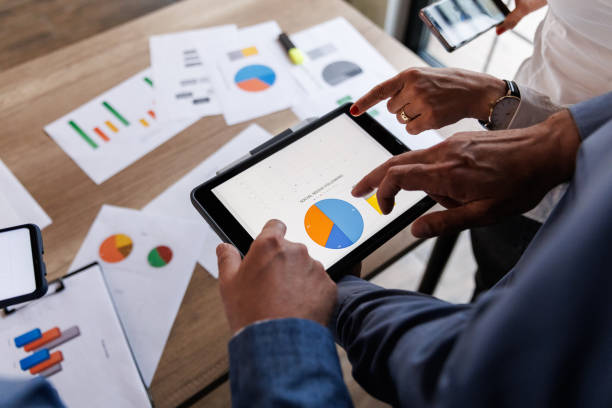 istock Businessman scrolling through various data on digital tablet during a meeting 1567328683