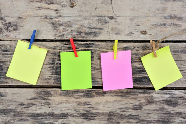 Colored Sticky Notes with copy space pinned to the wooden table stock photo