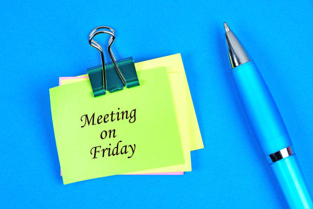 Meeting on friday words on notes paper stock photo
