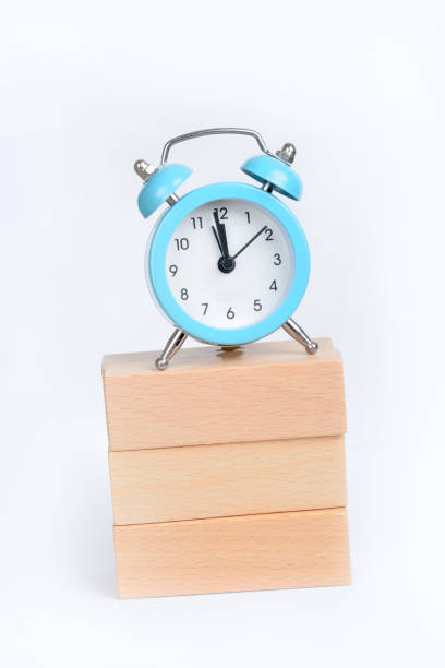 Alarm clock and wooden blocks on white background stock photo