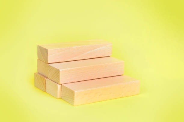 Blank wooden blocks on yellow background stock photo