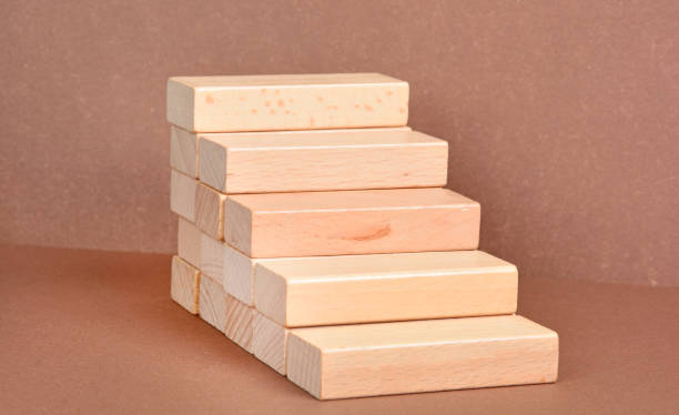 Block cubes on table over light brown wall stock photo