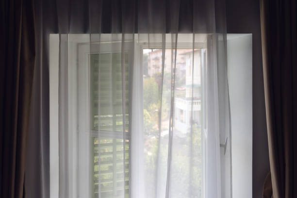 istock Window shutters and curtains at seaside apartment 1567347192