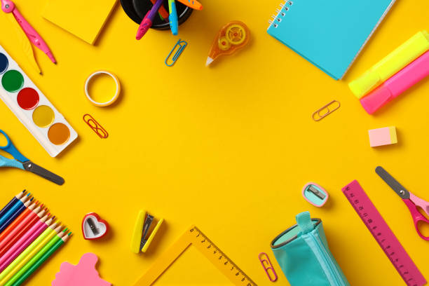 istock Back to school concept. School supplies frame on yellow background. Top view. Flat lay. 1567349676