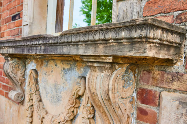 istock Crumbling limestone window ledge on fancy wall close up shot of abandoned structure 1567356579