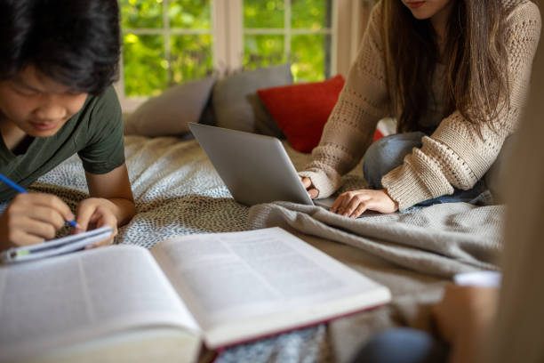 istock Group of students studying together at home 1567358235