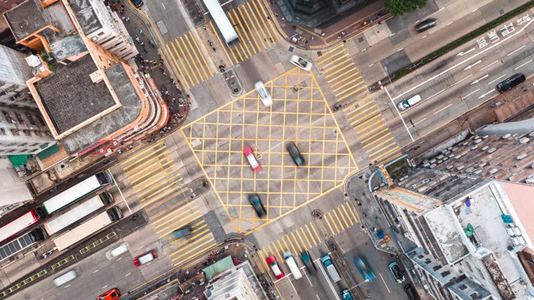 Aerial top view intersection and people crossing  road in Hong Kong City