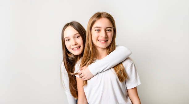 Two Young pre teen best friend girl on studio white The Two Young pre teen best friend girl on studio white cute teen pic stock pictures, royalty-free photos & images