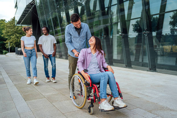 istock Young man enjoying a walk with his disabled female friend 1567361804