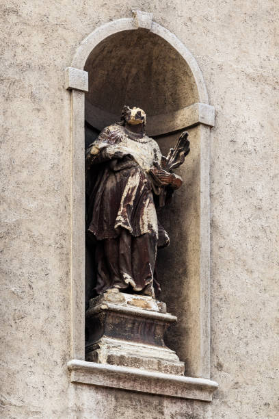 istock Worn and damaged statue at catholic church facade 1567362277