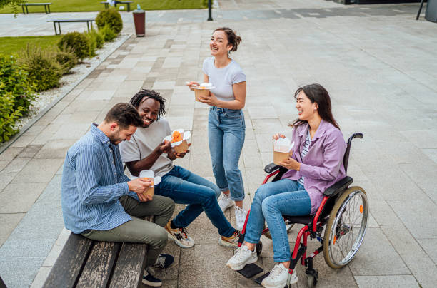 istock Friends having fun while eating together outdoors 1567366169