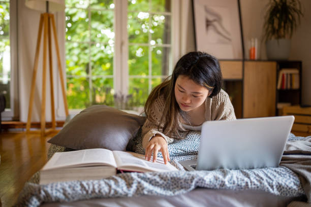istock Young woman using a laptop to study at home 1567368926