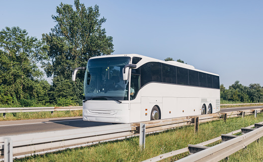 North Holland, the Netherlands - August 10, 2014: White coach bus VDL Bova Futura at the intercity road.