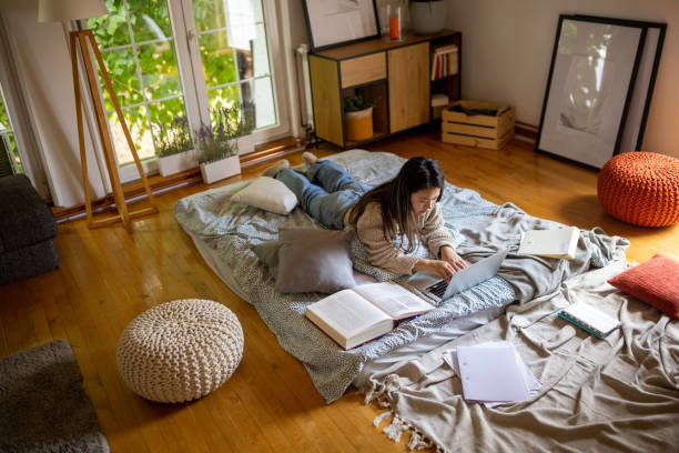 istock Young woman using a laptop to study at home 1567372274