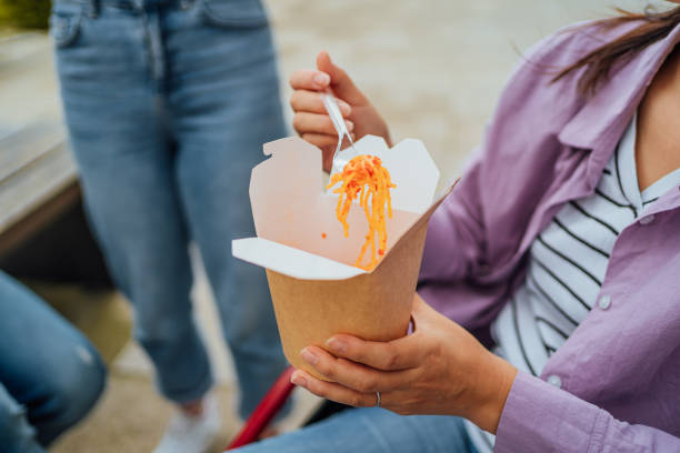 istock Woman eating a takeaway meal 1567375856