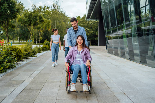 istock Young man enjoying a walk with his disabled female friend 1567377414