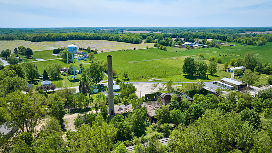 Image of Farm farmland summer silo, smokestack, collapsed abandoned building, water tower aerial