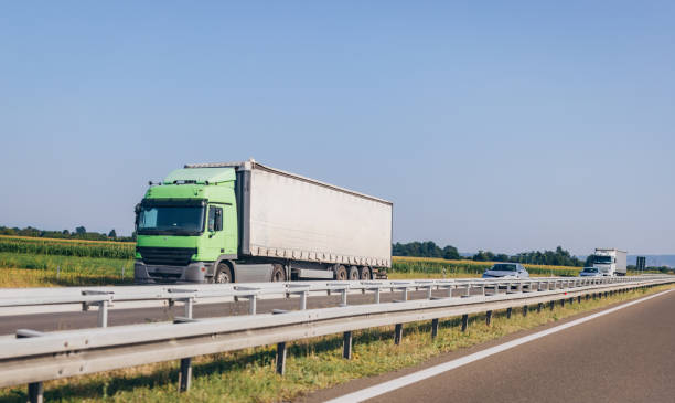 istock Cars and trucks on highway 1567386733