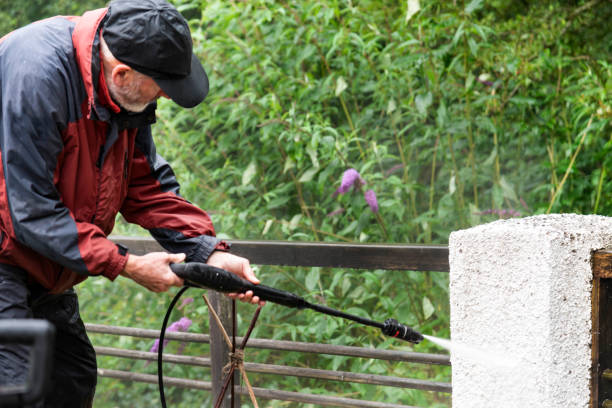 istock Man using a pressure washer cleaning a balcony - Stock photo 1567390755