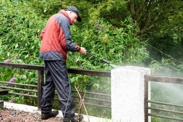 istock Man using a pressure washer cleaning a balcony - Stock photo 1567390764