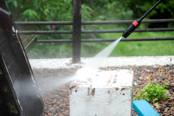 istock Man using a pressure washer cleaning a balcony - Stock photo 1567390788