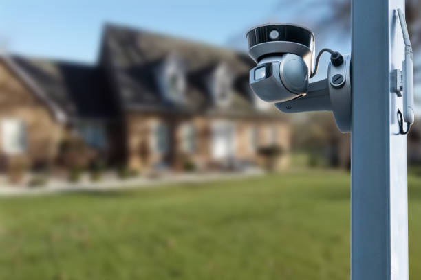 istock CCTV Camera or surveillance operating with house village in background. 1567393714