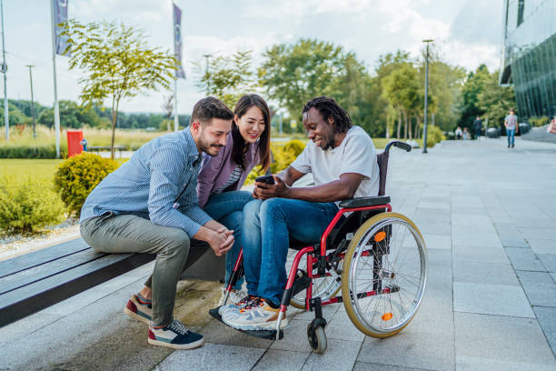 istock Cheerful friends using phone together outdoors 1567395398