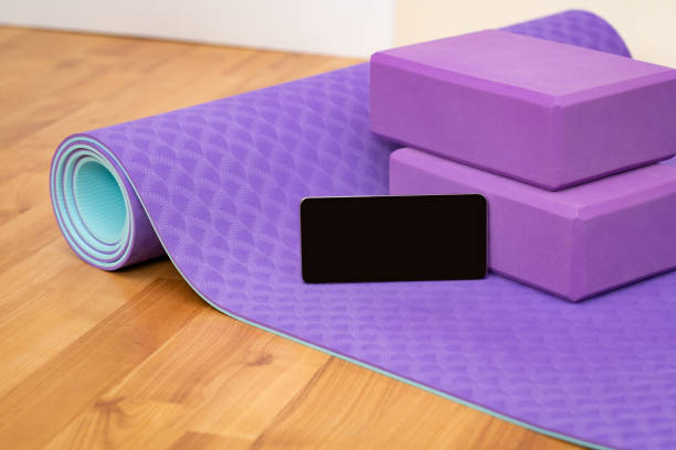 istock Blank phone on yoga mat with blocks 1567398213