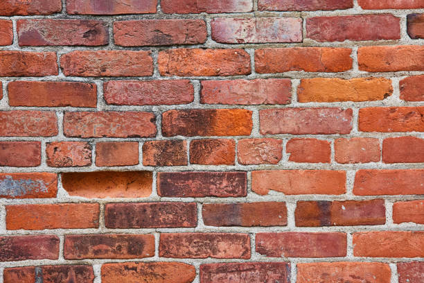 istock Horizontal brick wall with one indented brick and grimy surface with middle row being smaller bricks 1567400521