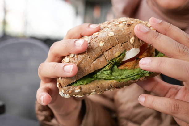 istock women eating organic vegan burger. 1567407559
