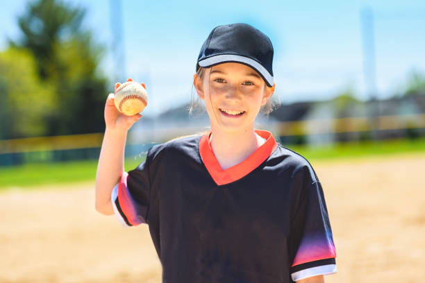 istock Young girl play baseball on summer day 1567413661