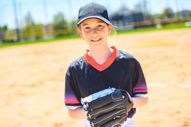 istock Young girl play baseball on summer day 1567414720