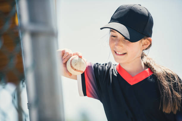istock Young girl play baseball on summer day 1567415167