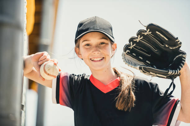 istock Young girl play baseball on summer day 1567415171