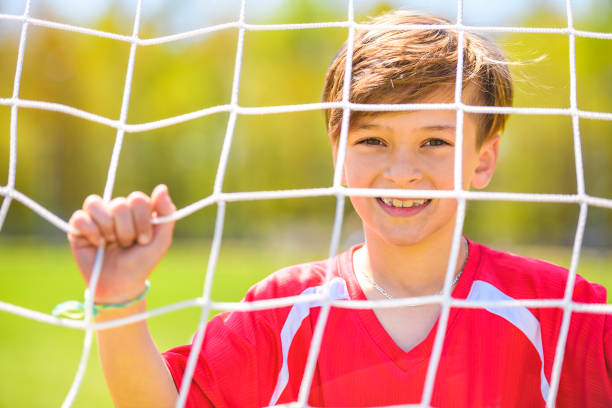 istock Little Boy play foot on summer day 1567417963