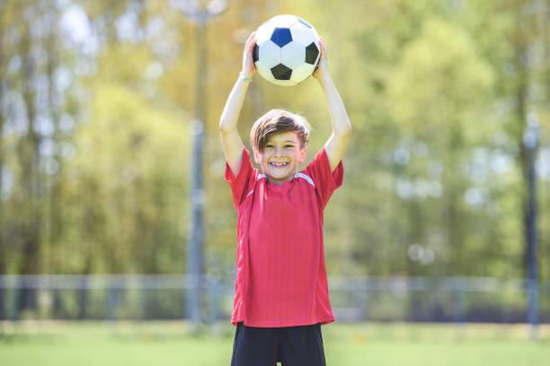 istock Little Boy play foot on summer day 1567417971