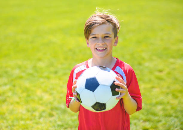 istock Little Boy play foot on summer day 1567417981