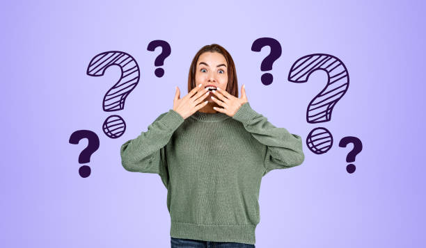istock Astonished young woman and question marks 1567421989