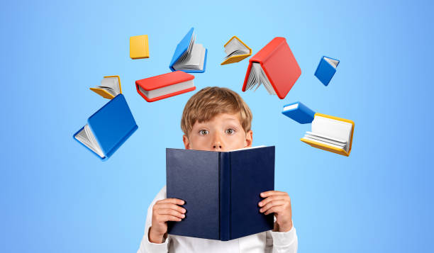 istock Kid with book in hands on blue background, education and creativity 1567424148