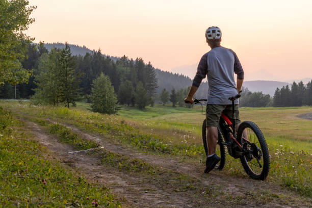 istock Senior male mountain biker pauses beside pathway 1567426873
