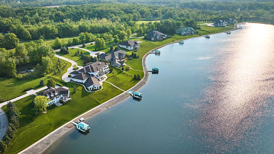 Image of Lakeside property aerial large homes with docks in water mansions
